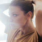 tying hair back woman bright morning light blog image support local